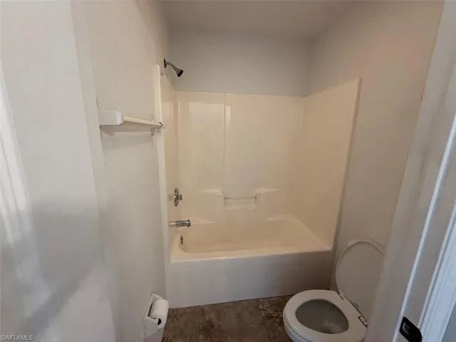 Bathroom featuring toilet and shower / tub combination