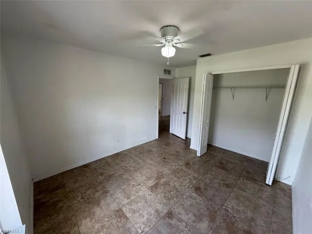 Unfurnished bedroom featuring a closet and ceiling fan