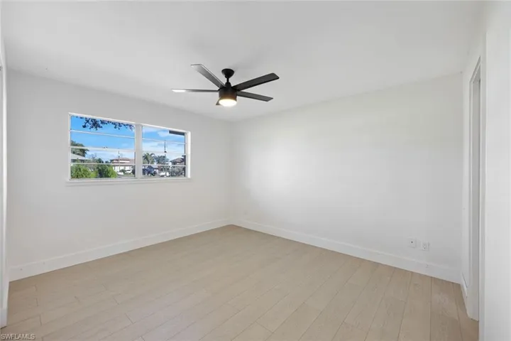 Spare room featuring ceiling fan and light hardwood / wood-style flooring