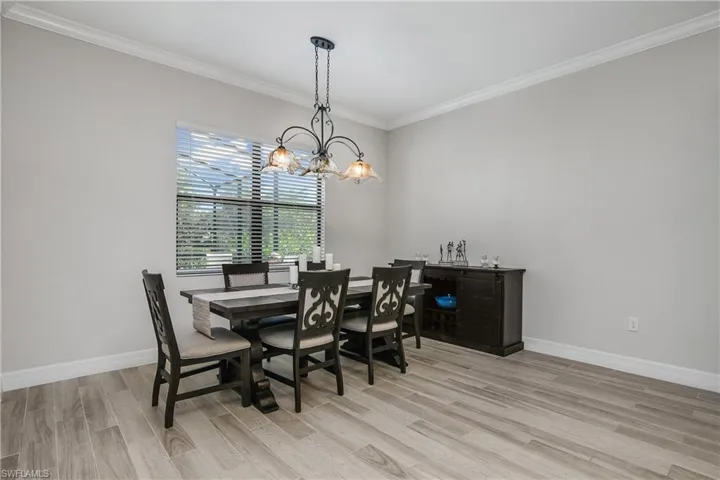 Elegant Chandelier  and Plank tiling to Accent Dining Area