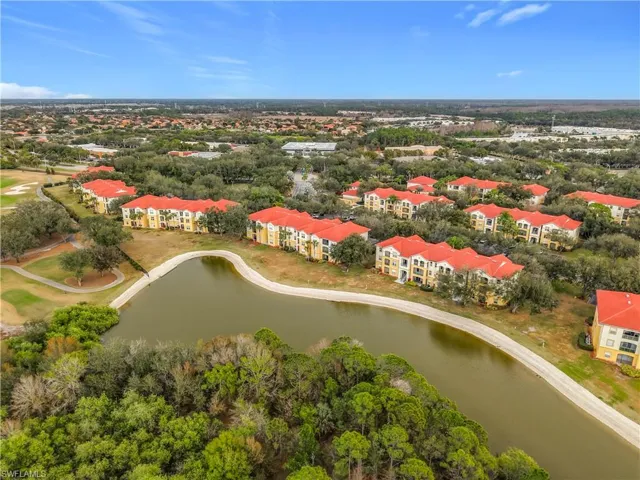 Drone / aerial view of a large body of water and apartment complex / building