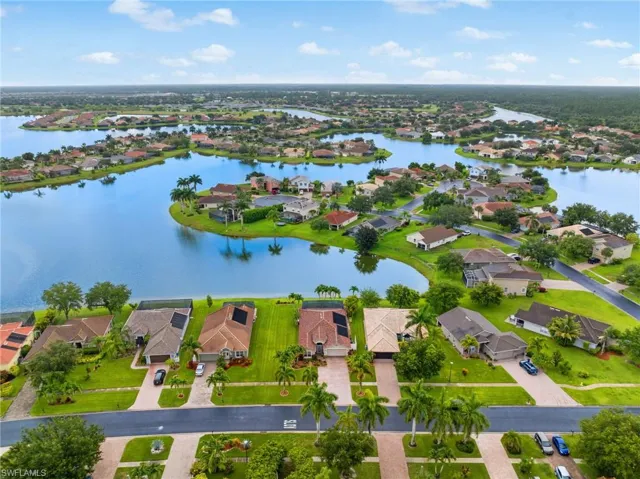 Birds eye view of property with a water view