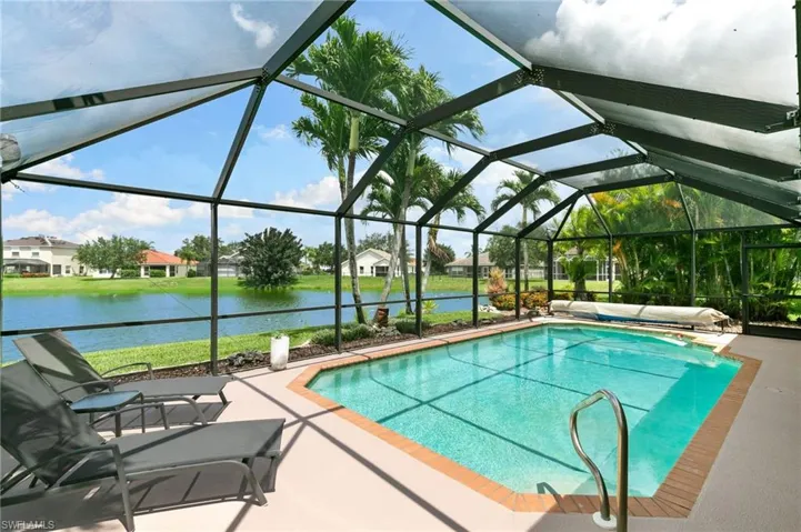 View of pool featuring a patio, a lanai, and a water view