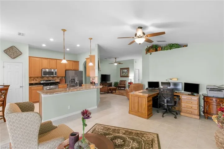 Tiled office space with sink and ceiling fan