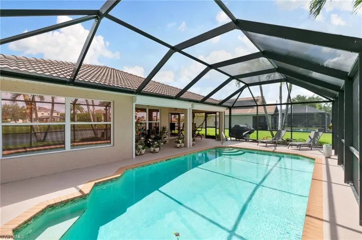 View of swimming pool featuring a lanai and a patio