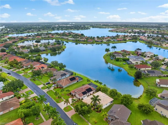 Birds eye view of property with a water view