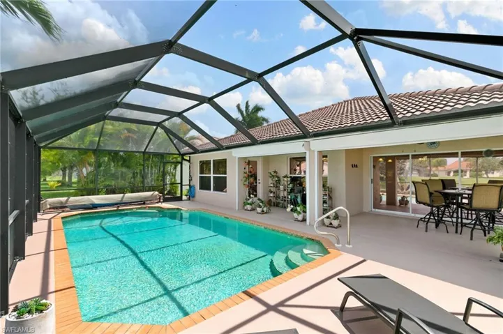 View of swimming pool with a patio area and a lanai
