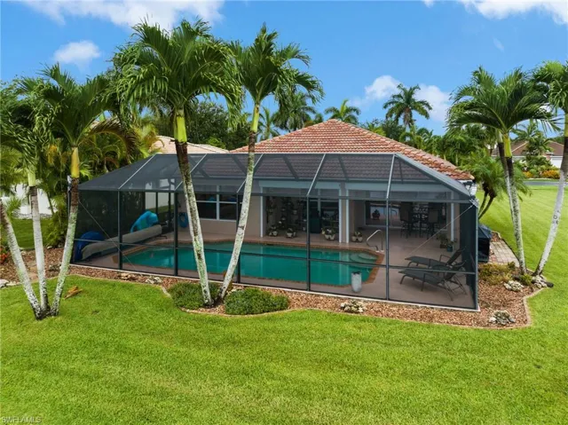 View of pool featuring a patio, a lanai, and a yard