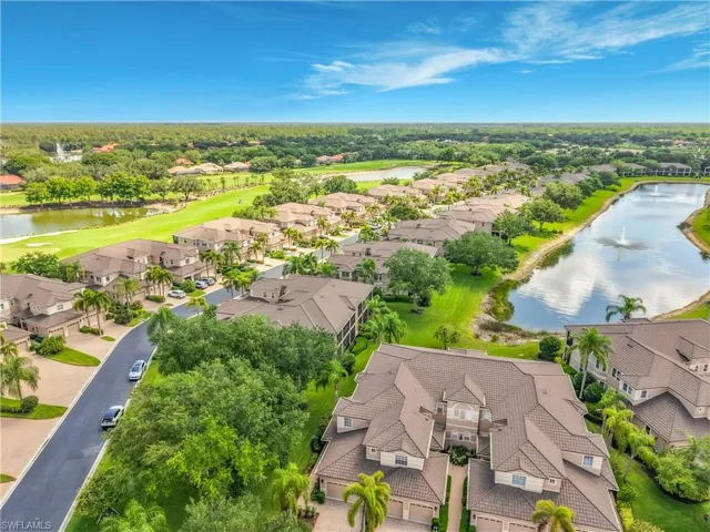 Aerial perspective showcasing multiple properties, a golf course, and two large water features with fountains