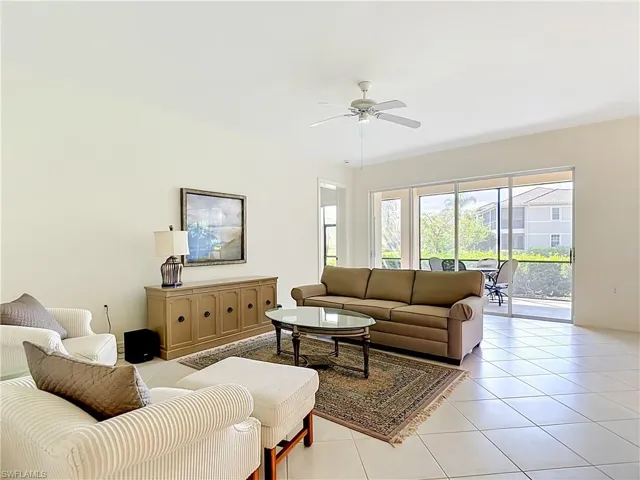 Spacious living area featuring tiled flooring and a ceiling fan