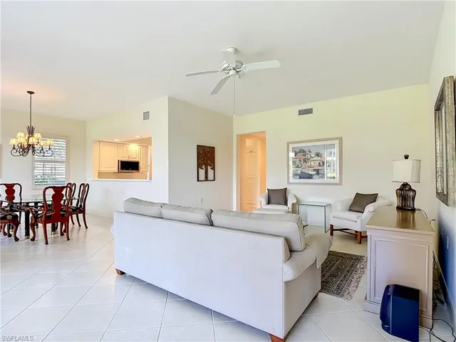 Open concept living area with vaulted ceilings, recessed lighting, and tile flooring throughout