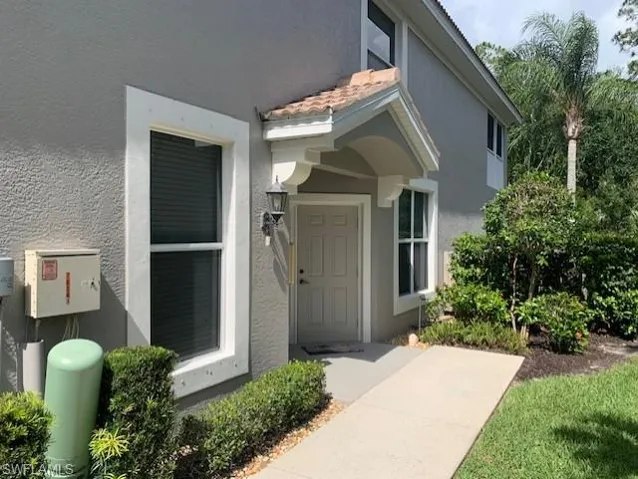Doorway to property featuring stucco siding