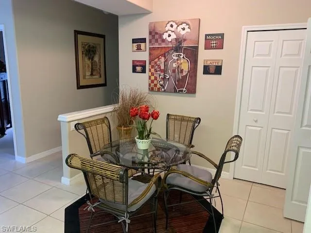Dining area featuring light tile patterned flooring and baseboards