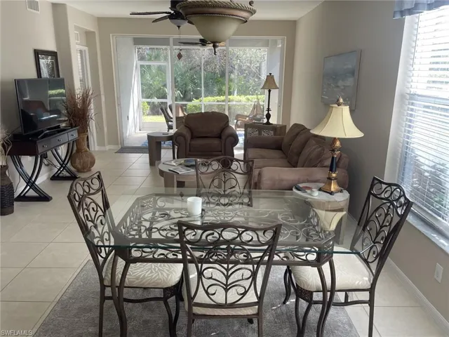 Dining area featuring light tile patterned floors and ceiling fan