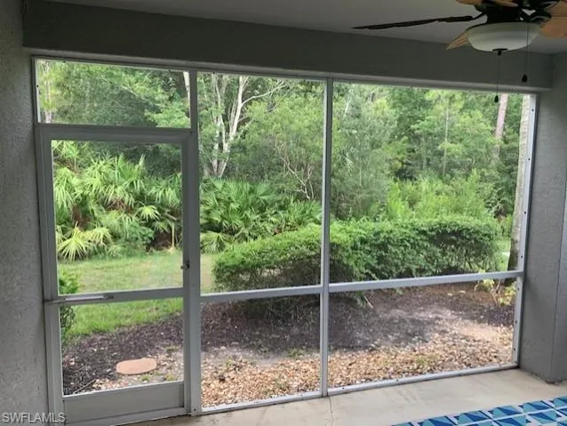 Unfurnished sunroom featuring a ceiling fan