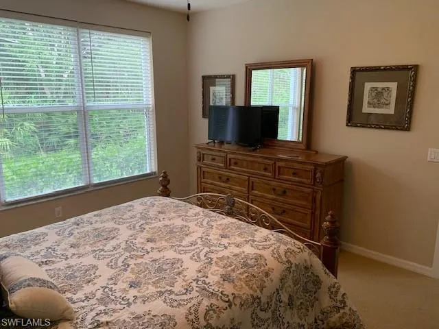 Bedroom featuring carpet flooring and baseboards