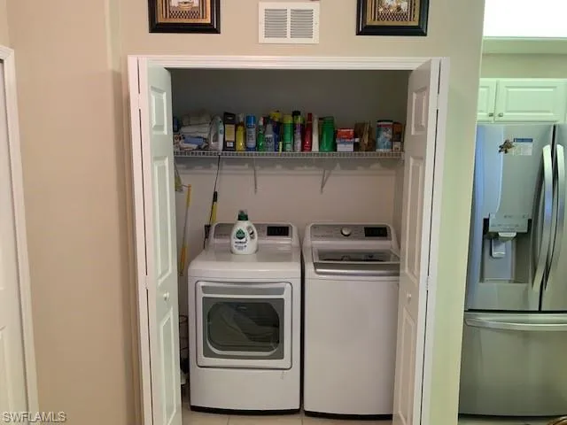 Washroom featuring washer and dryer