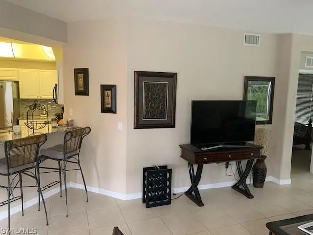 Living room with light tile patterned floors