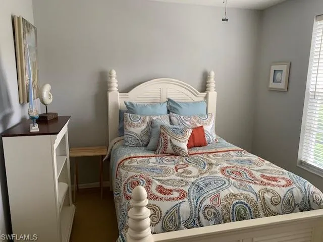 Bedroom with carpet flooring and baseboards