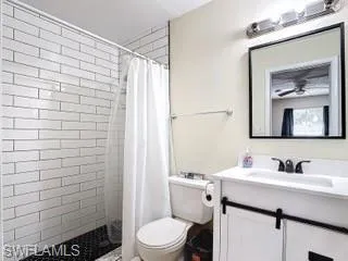 Full bathroom with vanity and a shower stall