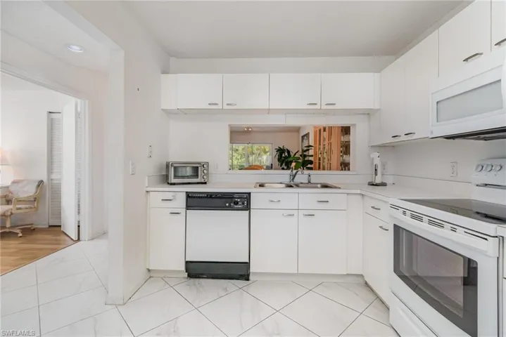 Current Kitchen- featuring white appliances, light countertops, and white cabinetry