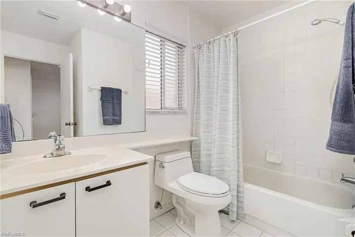 Guest bathroom with vanity, shower / bath combo