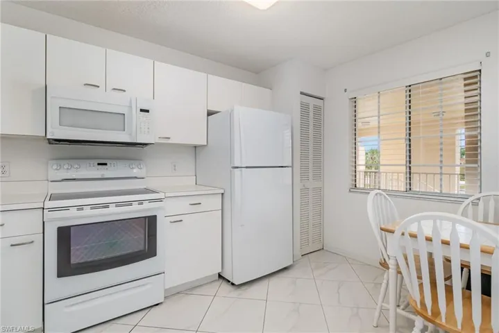 Current Kitchen- featuring white appliances, white cabinetry, and light countertops