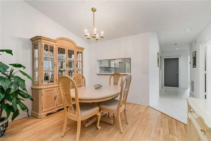 Dining area with light wood-type flooring, a chandelier, and recessed lighting