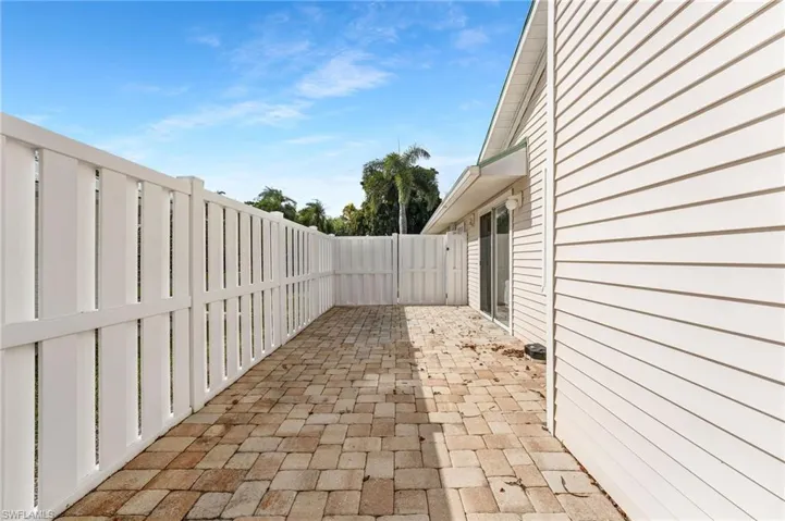 Your outdoor lanai runs the length of your home and is pavered and fenced for privacy.