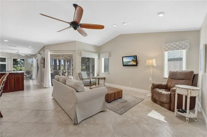 Tile floors are laid on the diagonal throughout the home, complementing the vaulted ceilings in the main living area. The open-concept layout is perfect for entertaining and offers direct access to the sun-filled screened lanai.