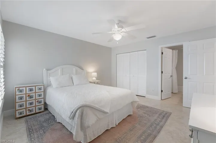 The spacious 2nd bedroom boasts an ensuite full bath and refined plantation shutters.