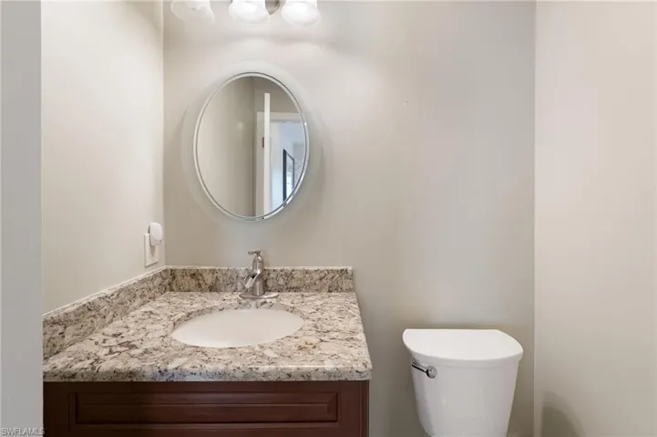 1/2 bath for guests has a granite topped vanity.