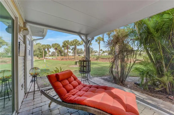 The screened lanai, featuring picture window screens and a pavered deck, is located off the primary suite—perfect for reading a good book or enjoying the view of golfers on the course.