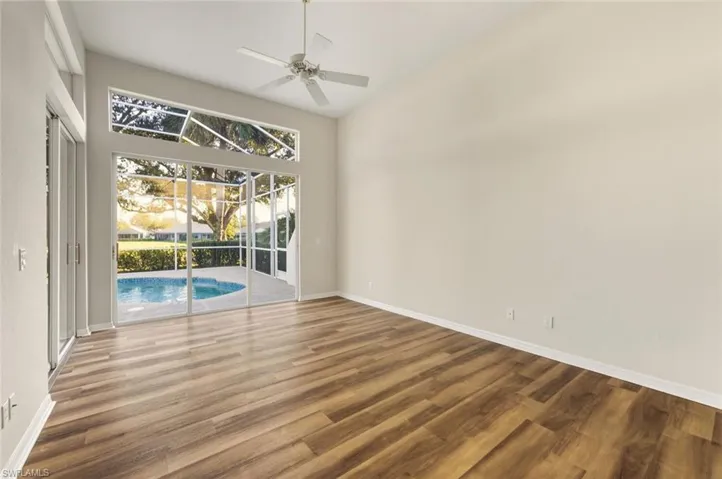 Staged - Quest Room Staged - Bedroom with wood finished floors and ceiling fan
