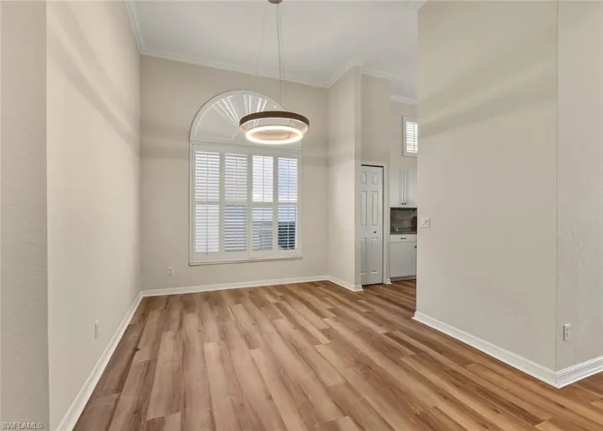 Foyer entrance featuring light wood-type flooring and crown molding