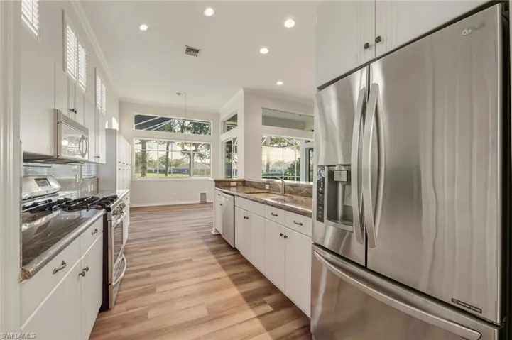 Unfurnished dining area with ornamental molding, dark wood-style floors, and a chandelier