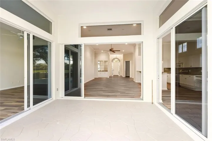 Staged - Living room featuring a warm lit fireplace, recessed lighting, wood finished floors, a chandelier, and ornamental molding