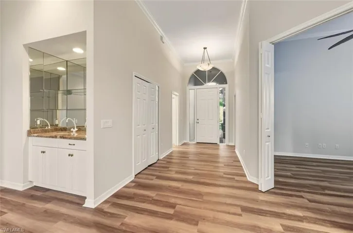Staged - Bedroom with access to outside, wood finished floors, and recessed lighting