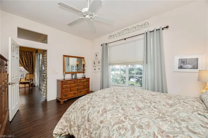 Bedroom featuring dark wood-type flooring and a ceiling fan