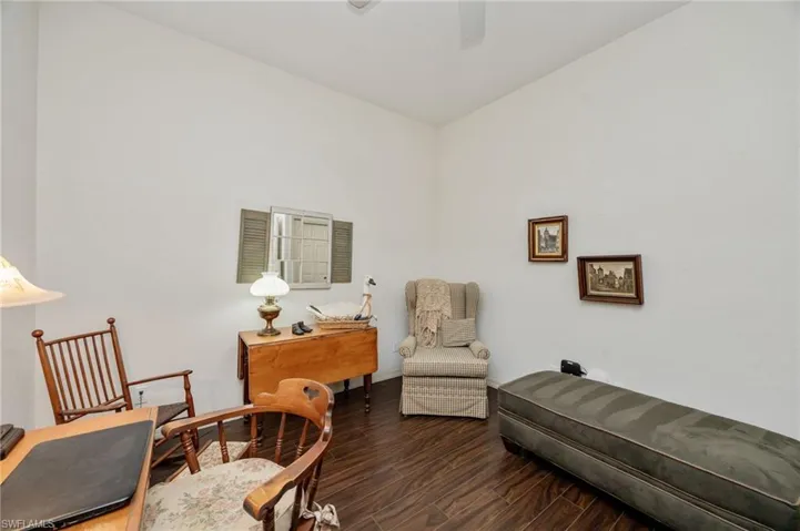 Living area featuring dark wood finished floors and a ceiling fan