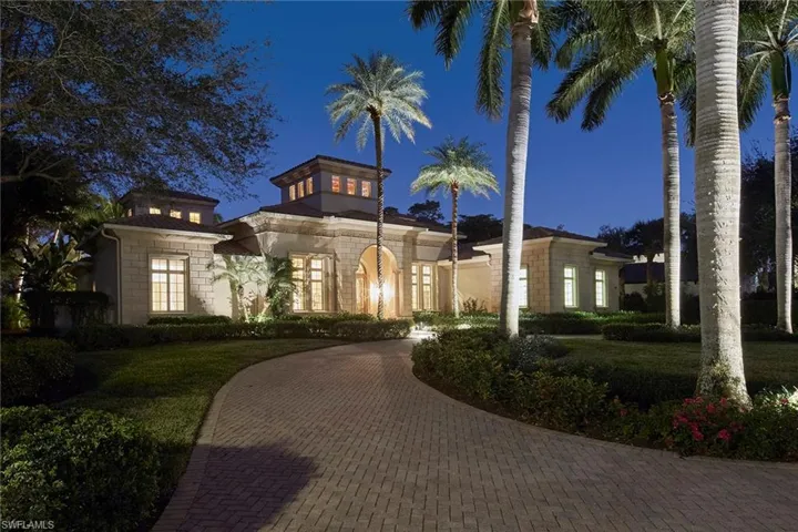 Mediterranean / spanish-style house featuring a lawn and stone siding