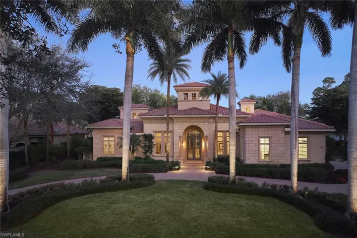 Mediterranean / spanish home featuring a tile roof, a lawn, a chimney, and stucco siding