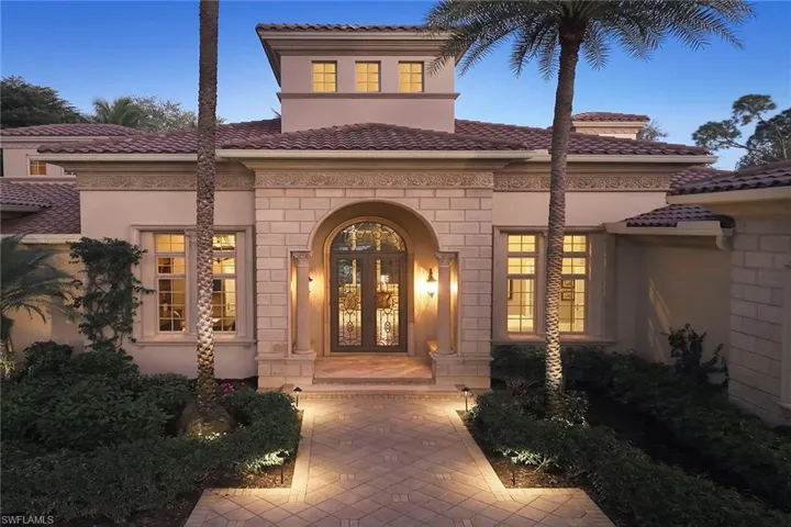 Doorway to property featuring stucco siding, french doors, and a tiled roof