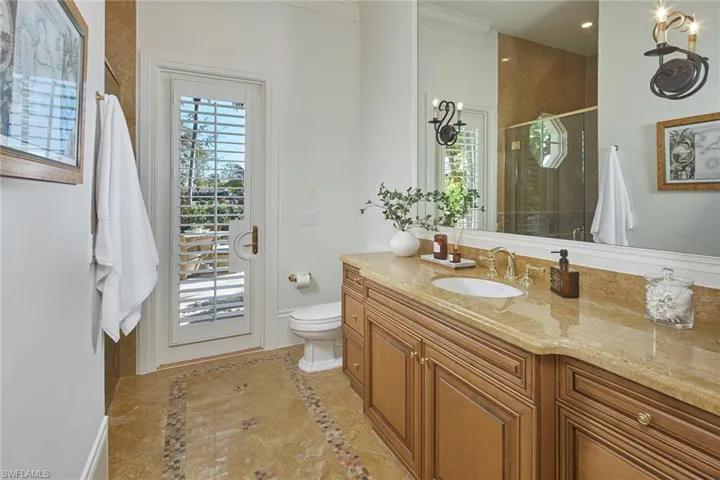 Full bathroom with vanity, a stall shower, plenty of natural light, and inlaid floor details