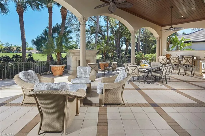 View of patio / terrace featuring ceiling fan, an outdoor living space with a fireplace, and outdoor dining space