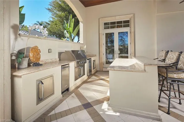 View of patio with area for grilling and french doors