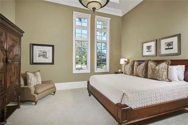 Bedroom with carpet flooring and crown molding