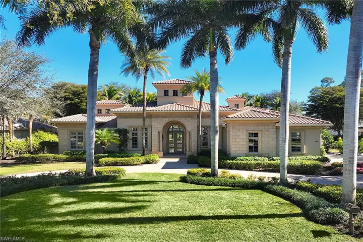 Mediterranean / spanish-style house with french doors, a front yard, stone siding, a tiled roof, and stucco siding