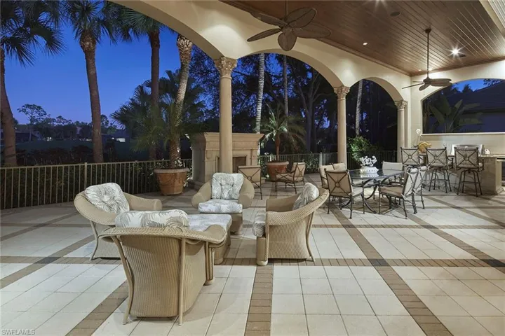 View of patio / terrace featuring a ceiling fan, an outdoor fireplace, and outdoor dining space