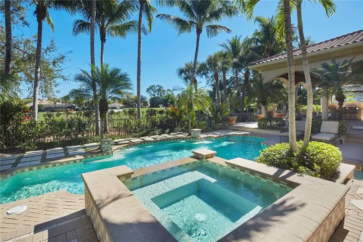 View of swimming pool featuring a patio area and a pool with connected hot tub